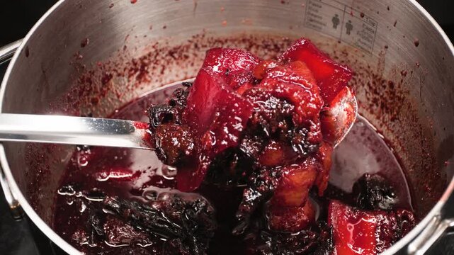 Close up cooking footage showing cooked ingredients for chamoy in pot during a homemade chamoy sauce recipe prepared from scratch