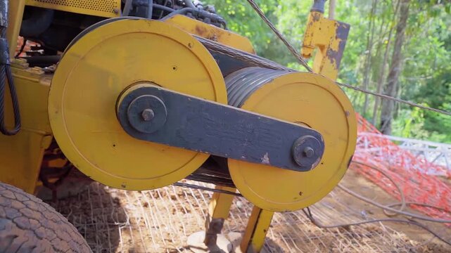 Close-up of a fiber optic cable running through a cable roller during telecommunications infrastructure installation in Minas Gerais, Brazil. Professional broadband network deployment for high-speed i