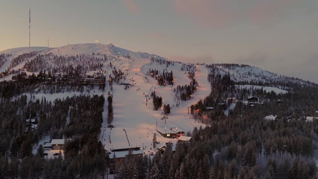 Aerial view around Pyh&auml; ski slopes illuminated at sunset in Lapland, Finland