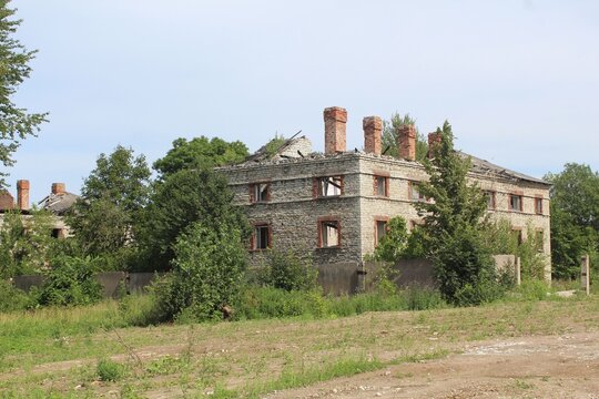 Derelict Abandoned Stone Building Ruins with Collapsed Roof and Overgrown Nature