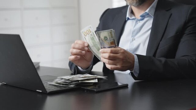 Businessman hold money in hand. Business finance management in office. Dollar counting machine concept. Finance office scene with cash counter. Financial management. Money counting and accounting.