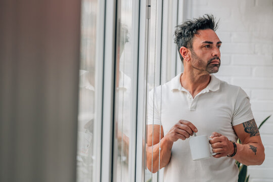 Businessman standing thoughtfully on a coffee break