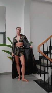 Woman wearing coordinated kimono robe with matching bralette and lounge shorts.