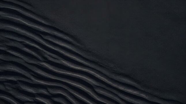 Volcanic black sand ripples macro texture background copy space