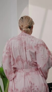 Woman wearing coordinated kimono robe with matching bralette and lounge shorts.