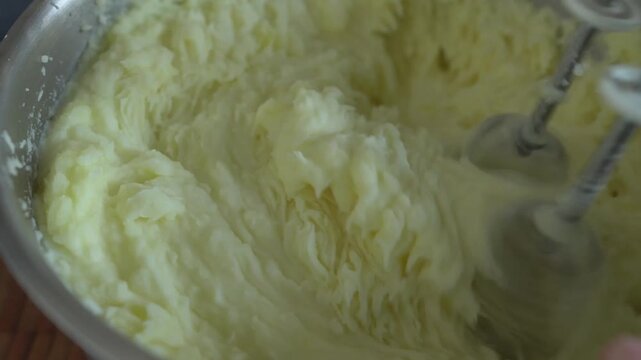 Mashed potatoes in a saucepan. Beating mashed potatoes with a mixer.