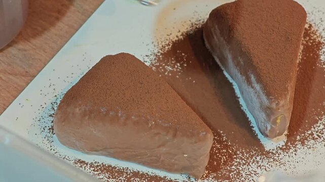 Coated with cocoa powder on mochi wrapped Dubai chocolate basque cheesecake.