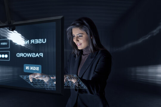 Smiling Businesswoman using virtual keyboard