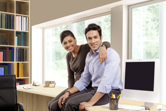 Smiling businessman and businesswoman in office