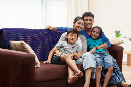 Portrait of family with two children on sofa