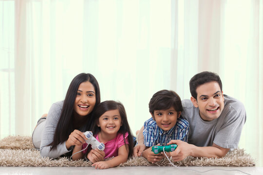 Family playing game with game console in living room