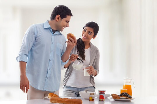 Couple enjoying breakfast at table