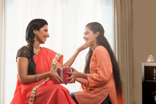 Daughter giving a gift to her mother 