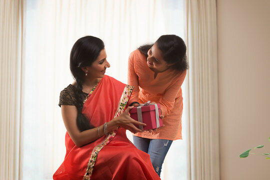 Daughter giving gift to her mother on mother's day