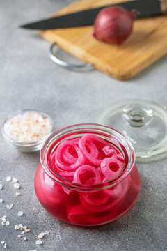 Homemade pickled red onion rings in a glass jar