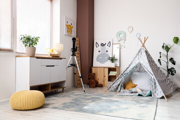 Cozy childrens room interior with a play tent, Wooden furniture, and decorative elements for a comfortable space © Pixel-Shot