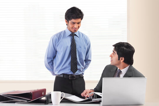 Two businessmen working together in office