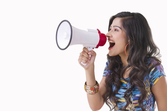 Young woman shouting through megaphone