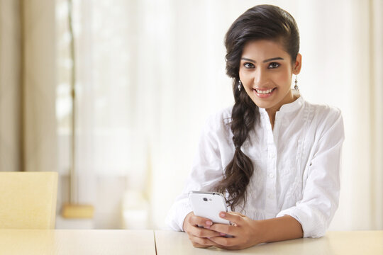 Beautiful young woman using mobile phone
