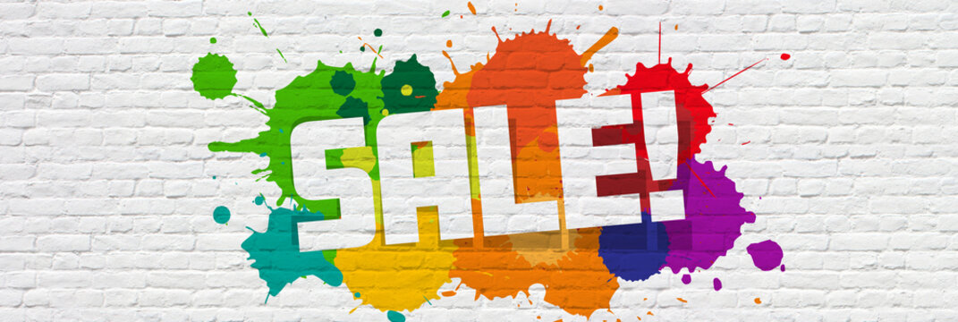 Sale! sign on a brick background with splashes of color