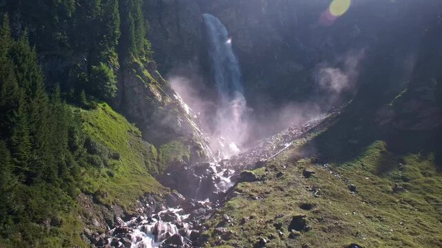 Staeubenfall Waterfall in Switzerland, Majestic Alpine Cascade in Mountain Valley. Spectacular Staubenfall Waterfall cascading down a rocky mountainside surrounded by evergreen forest.