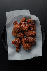 Top view of fried chicken wings on parchment paper © Cavan