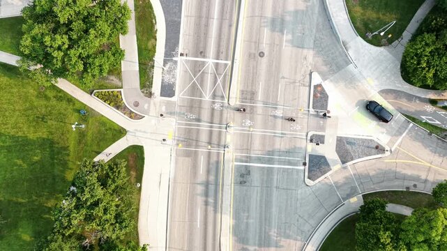 Top down aerial view of cyclists crossing an intersection