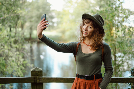 Happy young woman taking a selfie outdoors