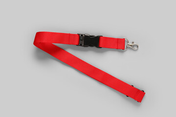 Obraz premium Red lanyard for badge on grey background