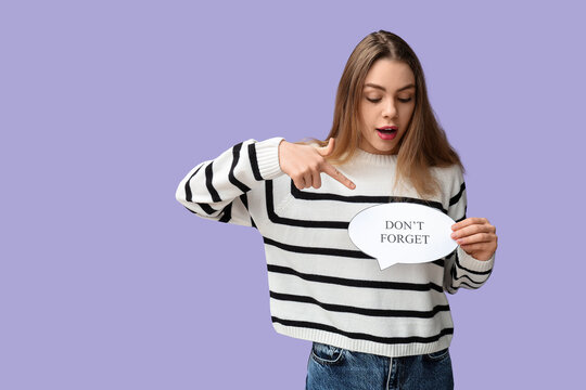 Young woman pointing at speech bubble with text DONT FORGET on lilac background. Reminder concept