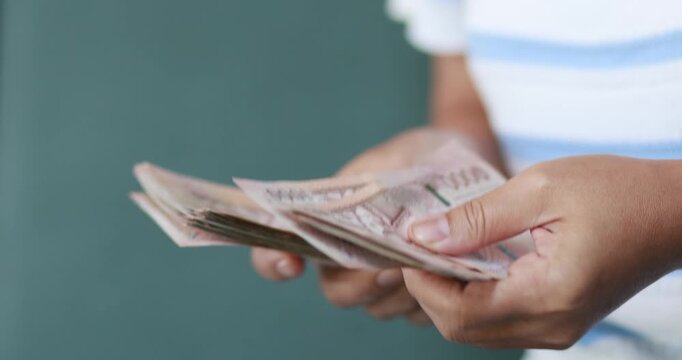 Hands counting Thai baht banknotes, finance and money, cash, savings, budgeting, income, expenses, investment, cash management, and financial security, close-up