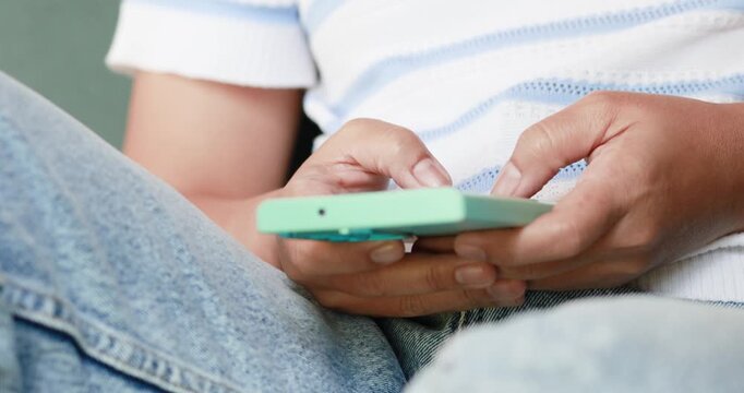 Hands typing and using a smartphone while sitting. Messaging and communication, texting, mobile apps, digital technology, social media, and modern lifestyle concepts, close-up