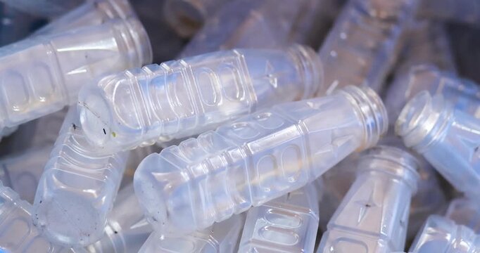 Used clear PET plastic bottles in a recycling bin. plastic waste management, sustainability, circular economy, and environmental conservation concepts, close-up