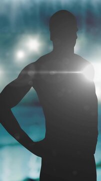Animation of silhouette of male swimmer over spotlights and swimming pool