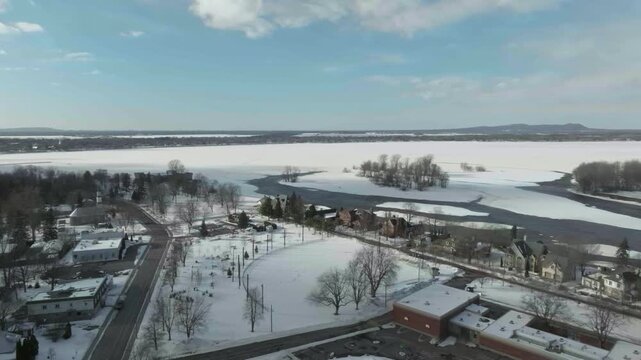 drone flying from primary school to the fort of chambly exposing the river in winterter quebec canada