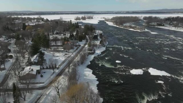 drone flying along the main river richeliaeu from damt to old town seeing the coast n the old houses n primary school