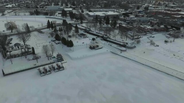 drone flying along the chambly channel a historic place in canada in the winter overlooking the new town n the marina