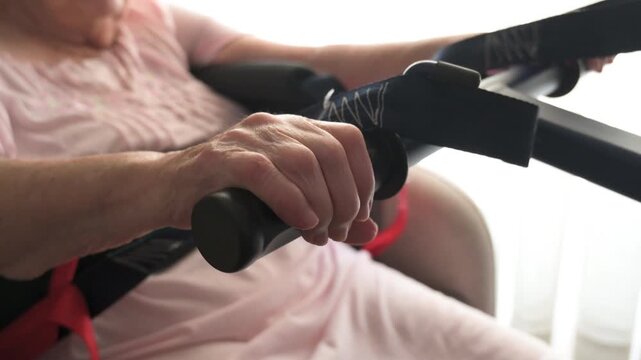 Close up of active patient hoist lifting senior woman during transfer at home