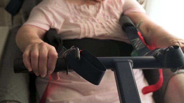 Close up of senior hands gripping transfer lift handlebar in safe mobility care