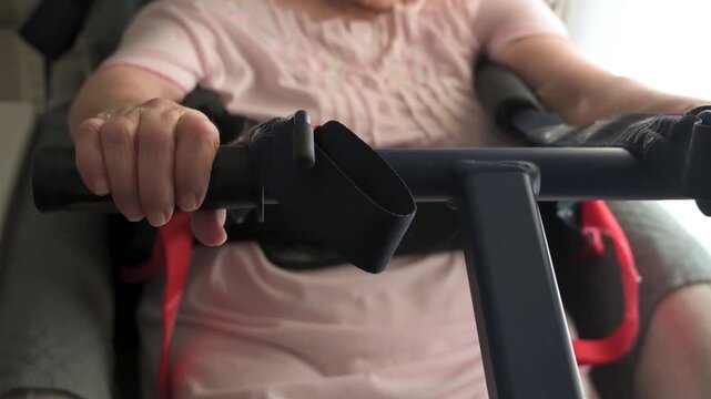 Close up of senior hands holding transfer lift handlebar during assisted care