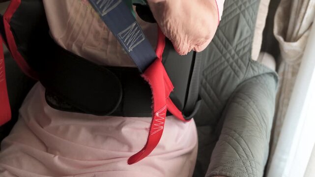 Close up of patient transfer lift harness and handle during senior seating care