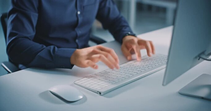 Business professional typing fast on wireless computer keyboard