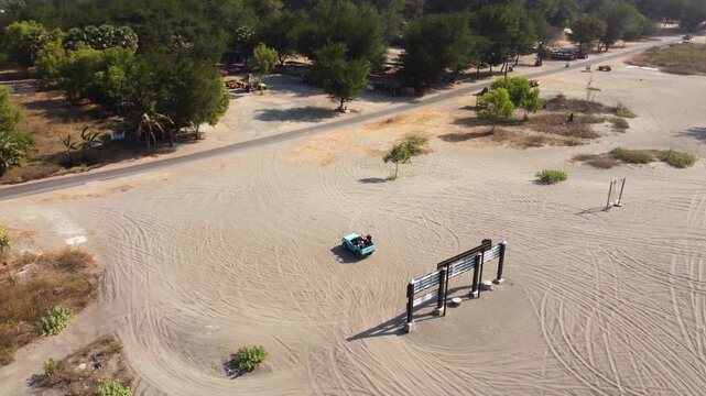 Aerial View of Tourists Taking Photos with Off Road Vehicle at Gumuk Pasir Parangkusumo Sand Dunes