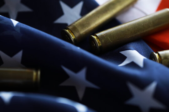 Many bullets cartridges and medals on United States flag. Concept of war glory victory. Gun trafficking on special operations