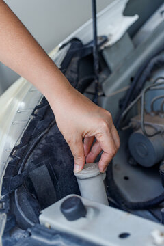 Close up of a hand of woman is checking a liquid coolant pot
