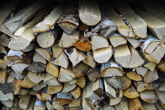 Stacked Cut Firewood Logs in a Pile: Ready for Winter Heating and Rustic Decor
