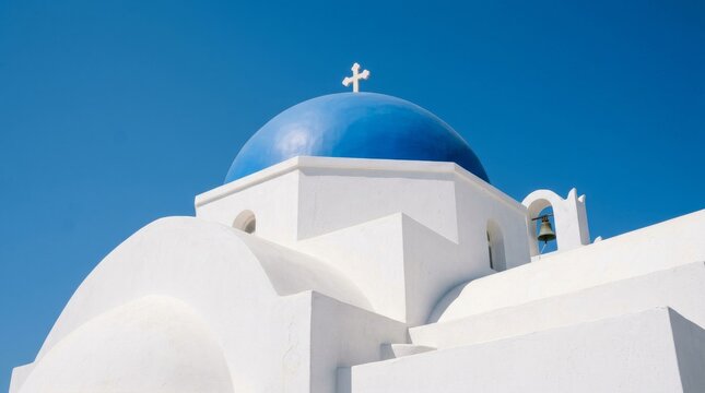 Classic Greek Orthodox church with iconic blue dome and white walls in Santorini Greece.
