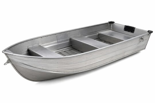 Empty aluminum rowboat floating on calm water. Small metal fishing boat ready for launch at lakeside dock.