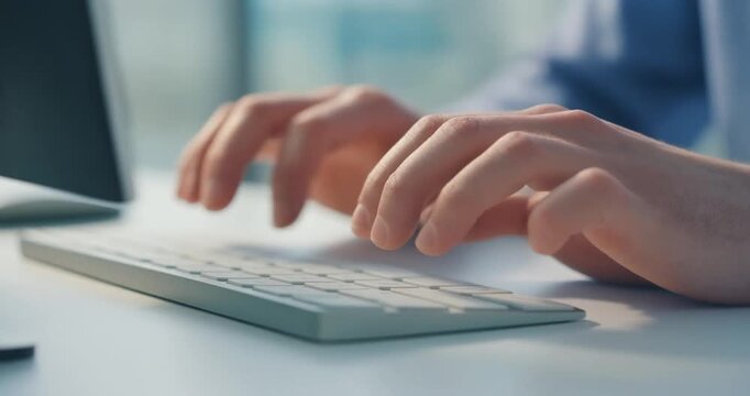 Man typing on keyboard focused on work motion