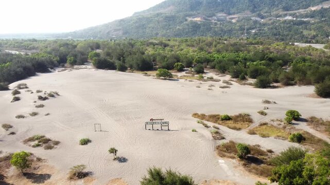 Aerial View of Gumuk Pasir Barchan Sand Dunes with Hills and Coastal Forest in Yogyakarta, Indonesia